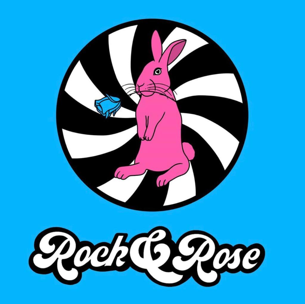 Rock and Rose Logo, which shows a pink rabbit holding a blue rose on its mouth.